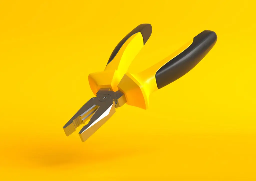 Yellow-black pliers isolated on yellow background